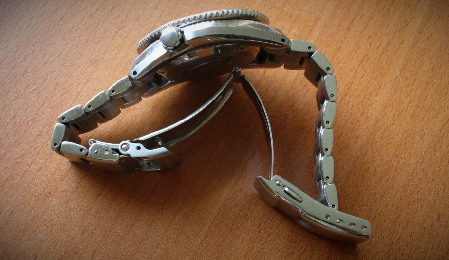 Curve-stamped clasp. Note how the steel bits have reliefing to give additional rigidity. 